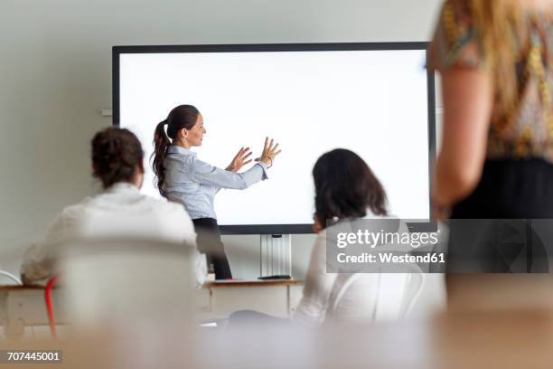 businesswoman leading a presentation - new colleague stock pictures, royalty-free photos & images