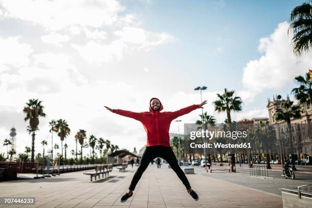 young man in the city jumping on pavement - jumping jack stock pictures, royalty-free photos & images