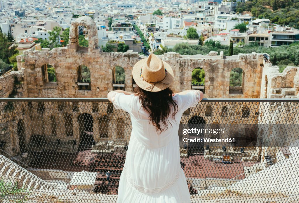 Greece, Athens, woman looking at The Odeon of Herodes Atticus at the slope of the Acropolis