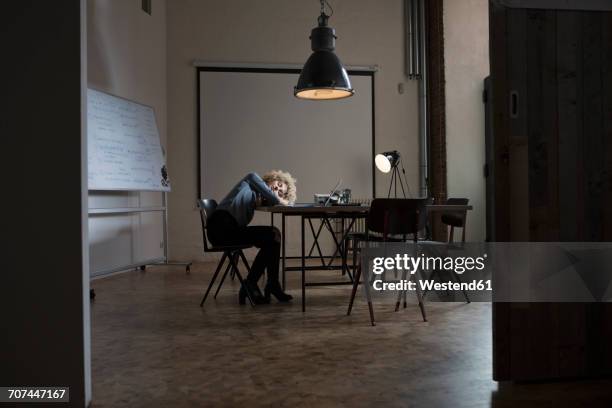 exhausted woman in boardroom - woman sleeping table stock pictures, royalty-free photos & images