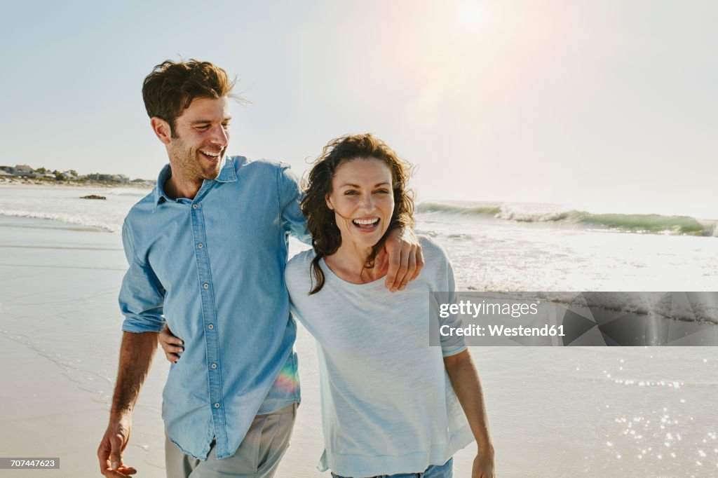 Laughing couple on the beach