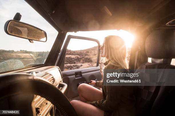 woman getting on car at sunset - entering atmosphere stock pictures, royalty-free photos & images