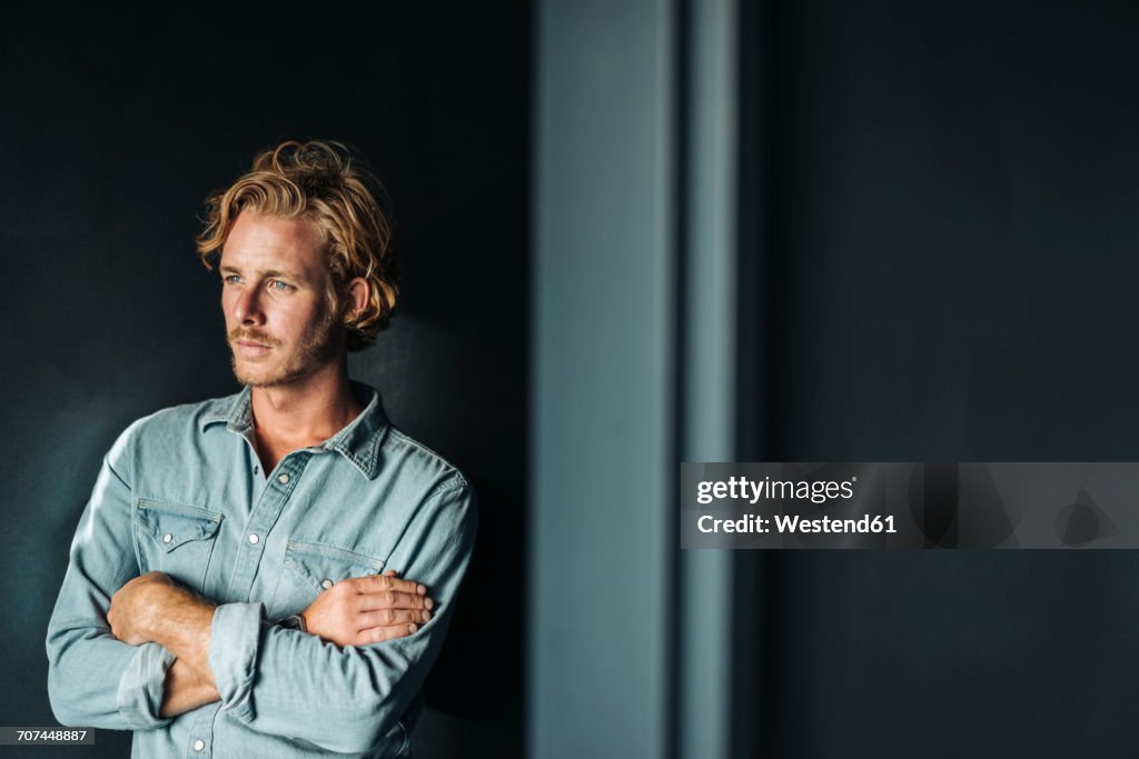 Portrait of confident blond man wearing white shirt