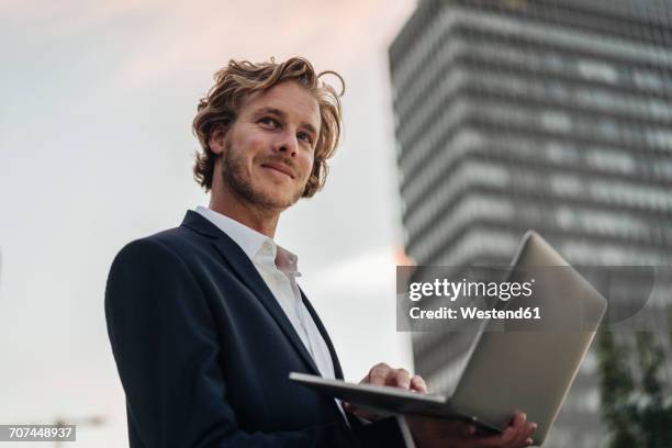 businessman using laptop outdoors - city low angle view stock pictures, royalty-free photos & images