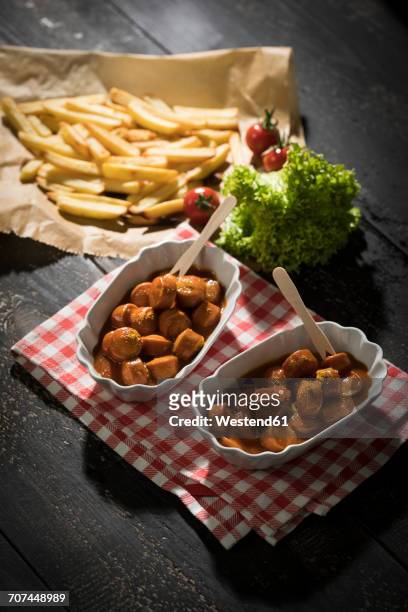 two bowls of currywurst and french fries in the background - currywurst stock pictures, royalty-free photos & images