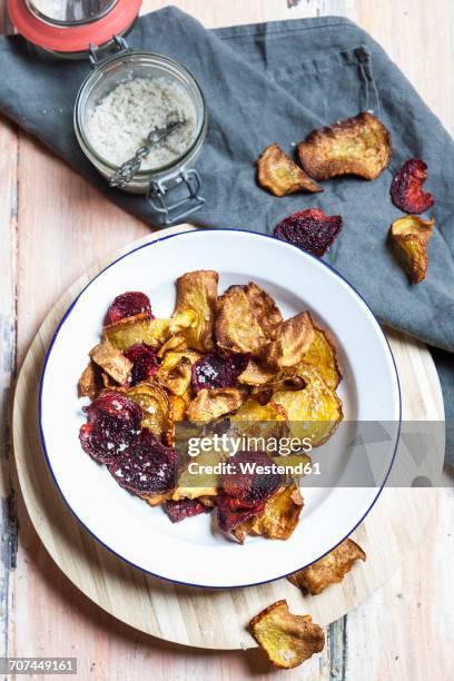 homemade vegetable chips made of beetroots and turnips with sea salt - vegetable chips stock pictures, royalty-free photos & images