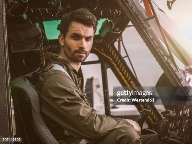 portrait of pilot in cockpit of a helicopter - stirn runzeln stock-fotos und bilder