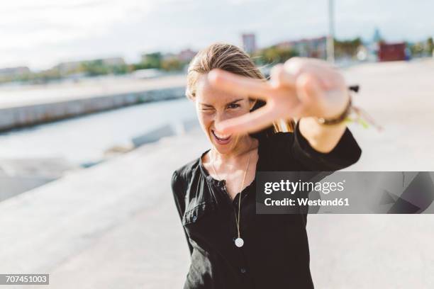 happy young woman posing outdoors - houding stockfoto's en -beelden