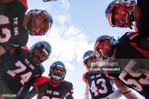 american football players in a huddle - team huddle stock pictures, royalty-free photos & images