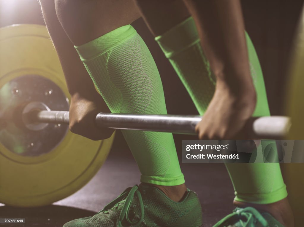 Close-up of woman preparing to lift barbell