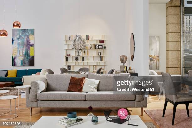showroom interior of a furniture shop with percent sign on coffee table - furniture store stock pictures, royalty-free photos & images