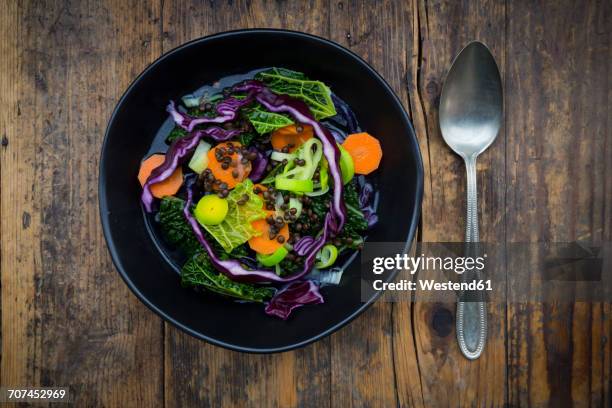 bowl of vegan cabbage stew with lentils on dark wood - savoykål bildbanksfoton och bilder