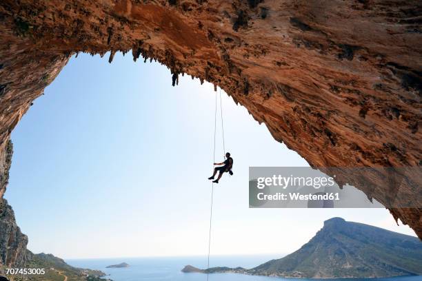 greece, kalymnos, climber abseiling in grotto - rápel fotografías e imágenes de stock