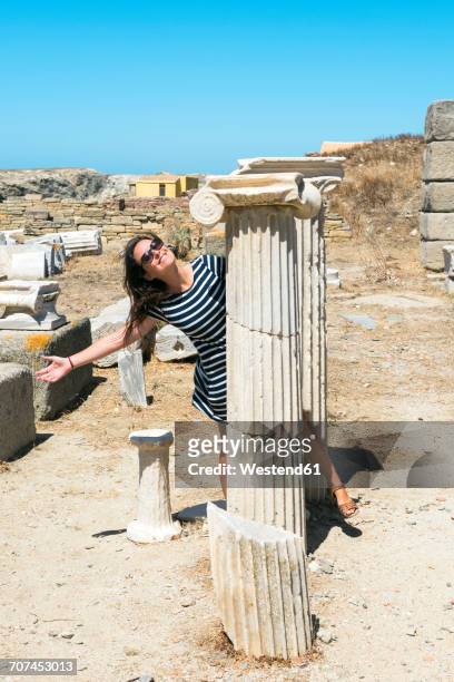 greece, mykonos, delos, happy woman visiting archaeological site - ancient greece photos stock-fotos und bilder