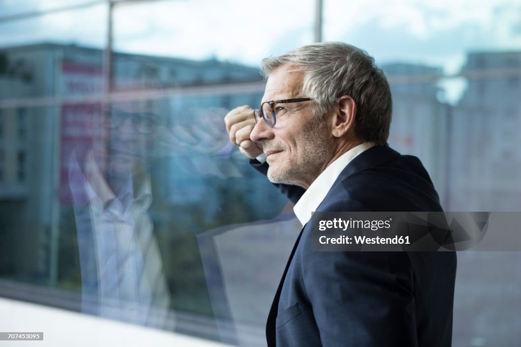 Confident businessman looking out of window