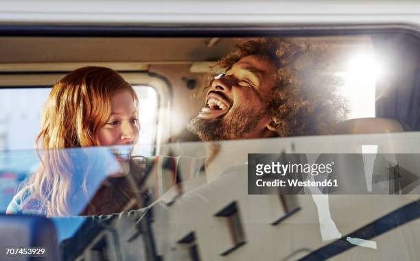 happy young couple in a car - car stock-fotos und bilder