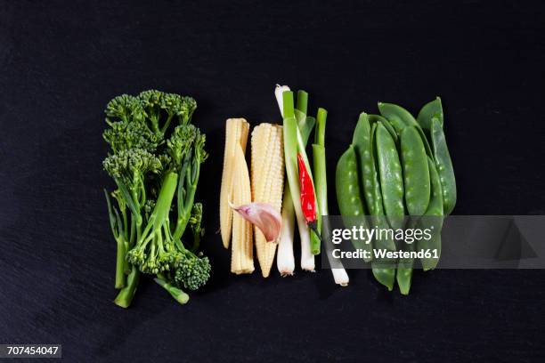 various fresh vegetables for wok on slate - エンドウマメの鞘 ストックフォトと画像