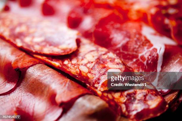 slices of spanish salami and italian ham, close-up - cold cuts fotografías e imágenes de stock