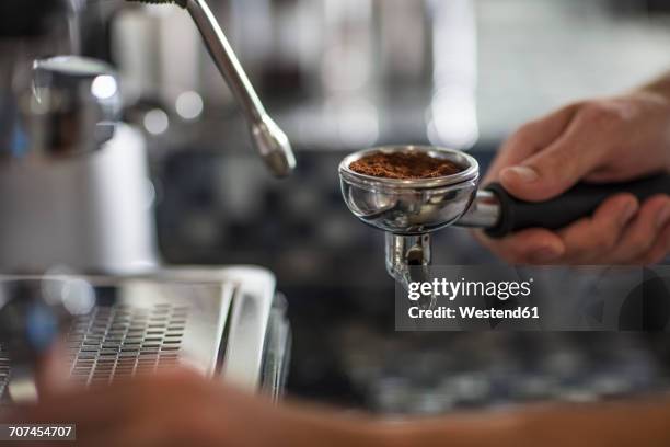 barista using espresso machine - coffee powder stock-fotos und bilder