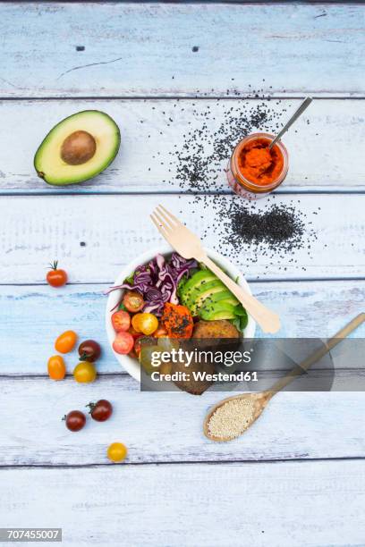 lunch bowls of leaf salad, red cabbage, avocado, tomatoes, quinoa fritters and ajvar - buddha bowl stock pictures, royalty-free photos & images