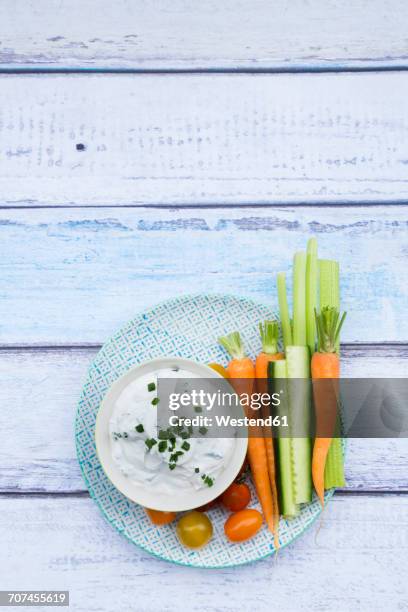 bowl of herb yoghurt dip, cherry tomatoes and vegetable sticks on plate - crudites stock pictures, royalty-free photos & images