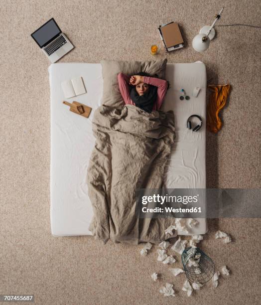 sick woman lying in bed, top view - bed above stock pictures, royalty-free photos & images