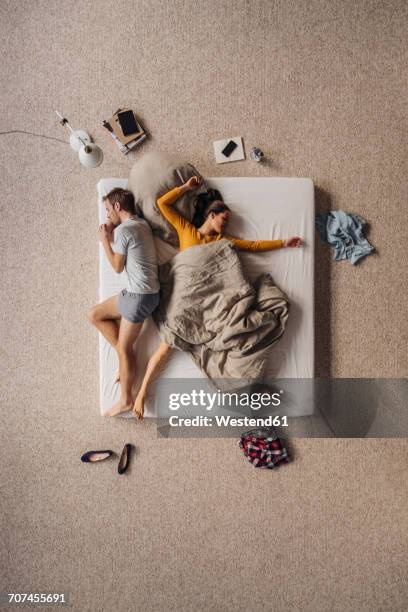 couple lying in bed, top view - two houses side by side stock pictures, royalty-free photos & images