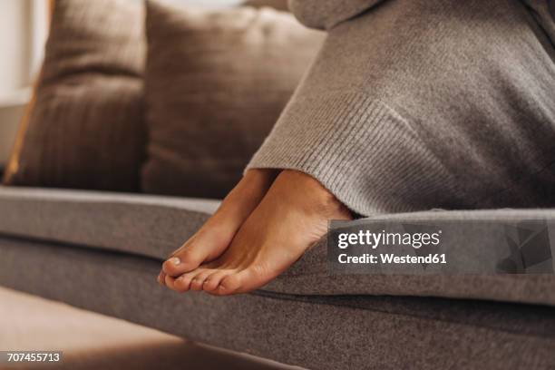 close-up of woman's feet sitting on couch - human foot stock pictures, royalty-free photos & images