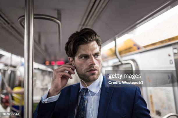 businessman in metro using smart phone - underground train stock pictures, royalty-free photos & images