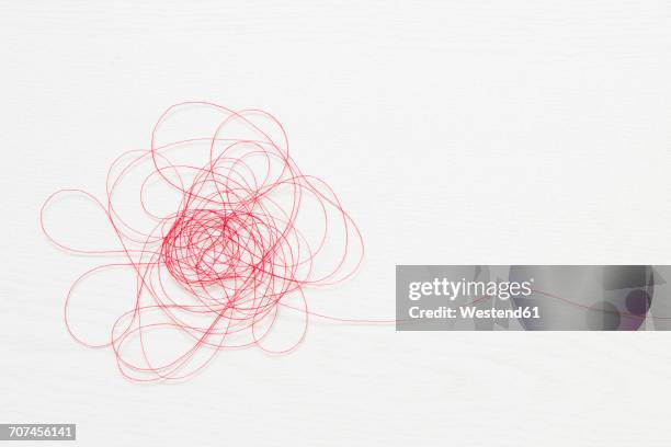 red thread on white background - thread stock-fotos und bilder