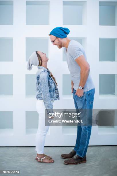 short woman and tall man laughing at each other - short guy tall woman stock pictures, royalty-free photos & images