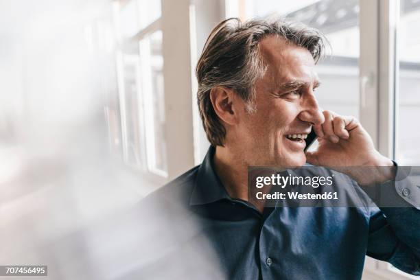 smiling mature businessman talking on cell phone - button down shirt close up stock pictures, royalty-free photos & images