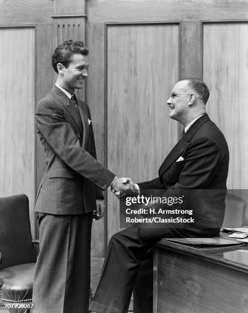 1940s TWO MEN SHAKING HANDS CONCLUSION OF BUSINESS DEAL