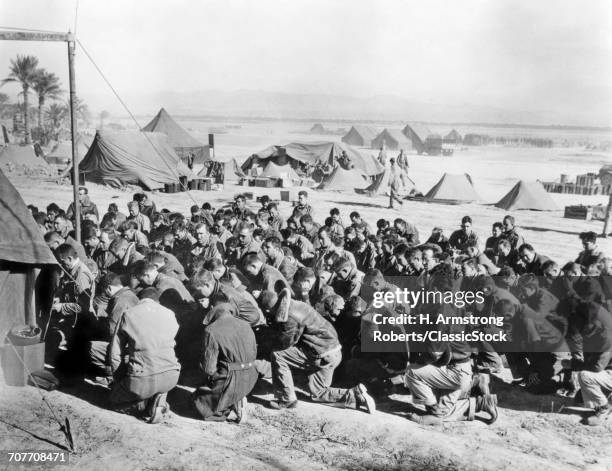 1940s U.S. ARMY SOLDIERS ATTEND CHURCH SERVICES ON A TROPICAL BEACH