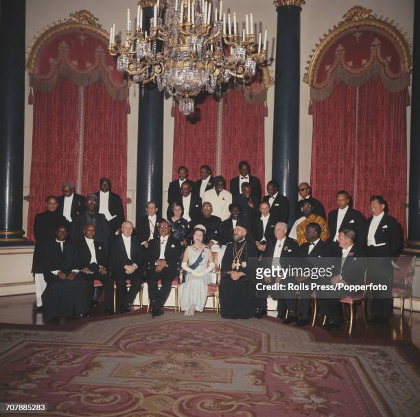 Queen Elizabeth II pictured in centre front row with Commonwealth Prime Ministers as they attend a dinner at Buckingham Palace in London on 7th...