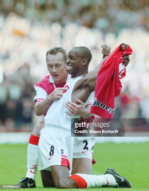 Ian Wright of Arsenal football club takes off his shirt and celebrates with team mate Lee Dixon after breaking Cliff Bastin's Arsenal goalscoring...