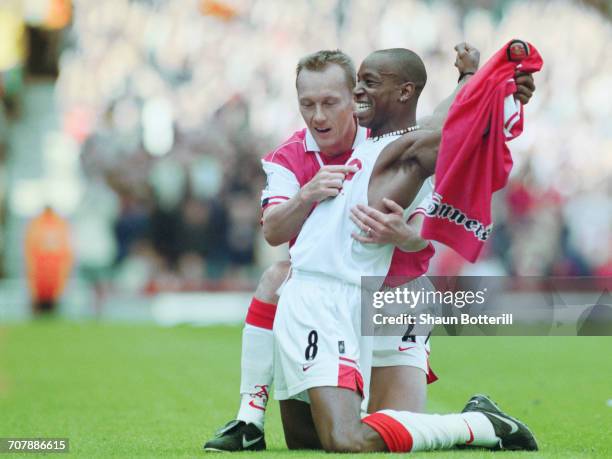 Ian Wright of Arsenal football club takes off his shirt and celebrates with team mate Lee Dixon after breaking Cliff Bastin's Arsenal goalscoring...