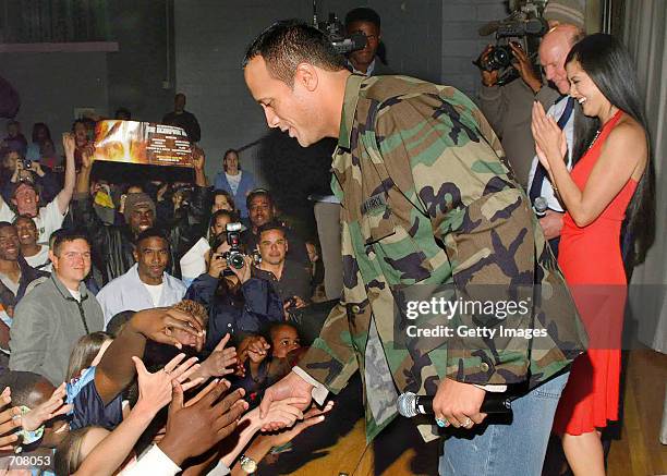 World Wrestling Federation superstar The Rock , actress Kelly Hu , and Maj. Gen. Doug Pearson, Air Force Flight Test Center commander, greet about...