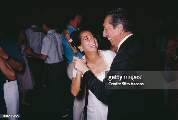 English actress Merle Oberon dancing with former president of Mexico, Miguel Alemán Valdés , at a party in Acapulco, Mexico, February 1966.