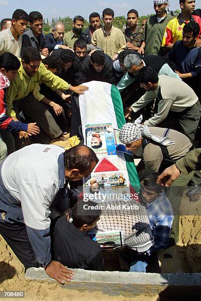 Relatives of Esam el- Dreamly, killed last week by Israeli troops in Nablus, bury his flag-draped coffin in the Islamic cemetery known as the...