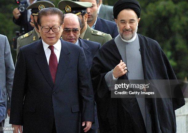 Chinese President Jiang Zemin and Iranian President Mohammad Khatami walk into Saadabad palace April 20, 2002 in Tehran. Iranian and Chinese...