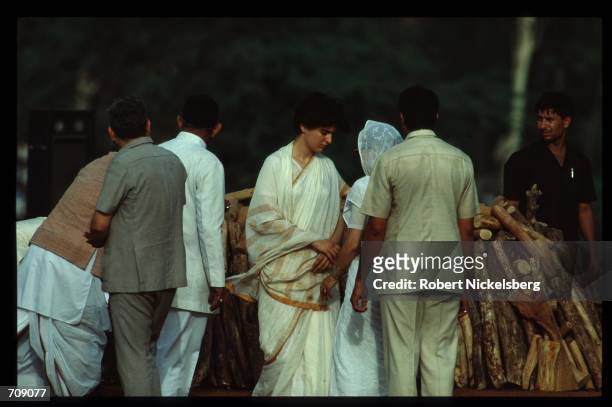 Prime Minister Rajiv Gandhis wife Sonia and daughter Priyanka stands near the pyre holding Gandhis body May 24, 1991 in New Delhi, India. Gandhi was...