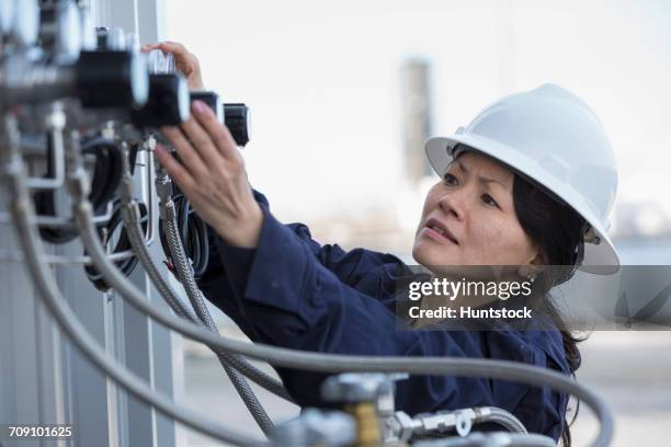 female power engineer checking transducer at power station - transducer stock pictures, royalty-free photos & images