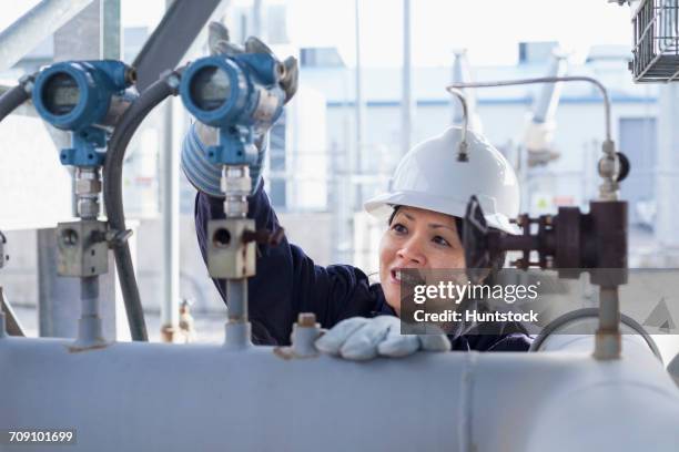 female power engineer checking pressure transducers at power plant - transducer stock pictures, royalty-free photos & images