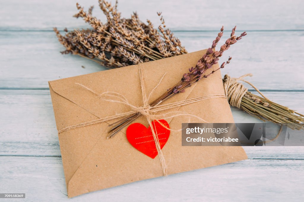 Envelope with heart sticker and dried flowers