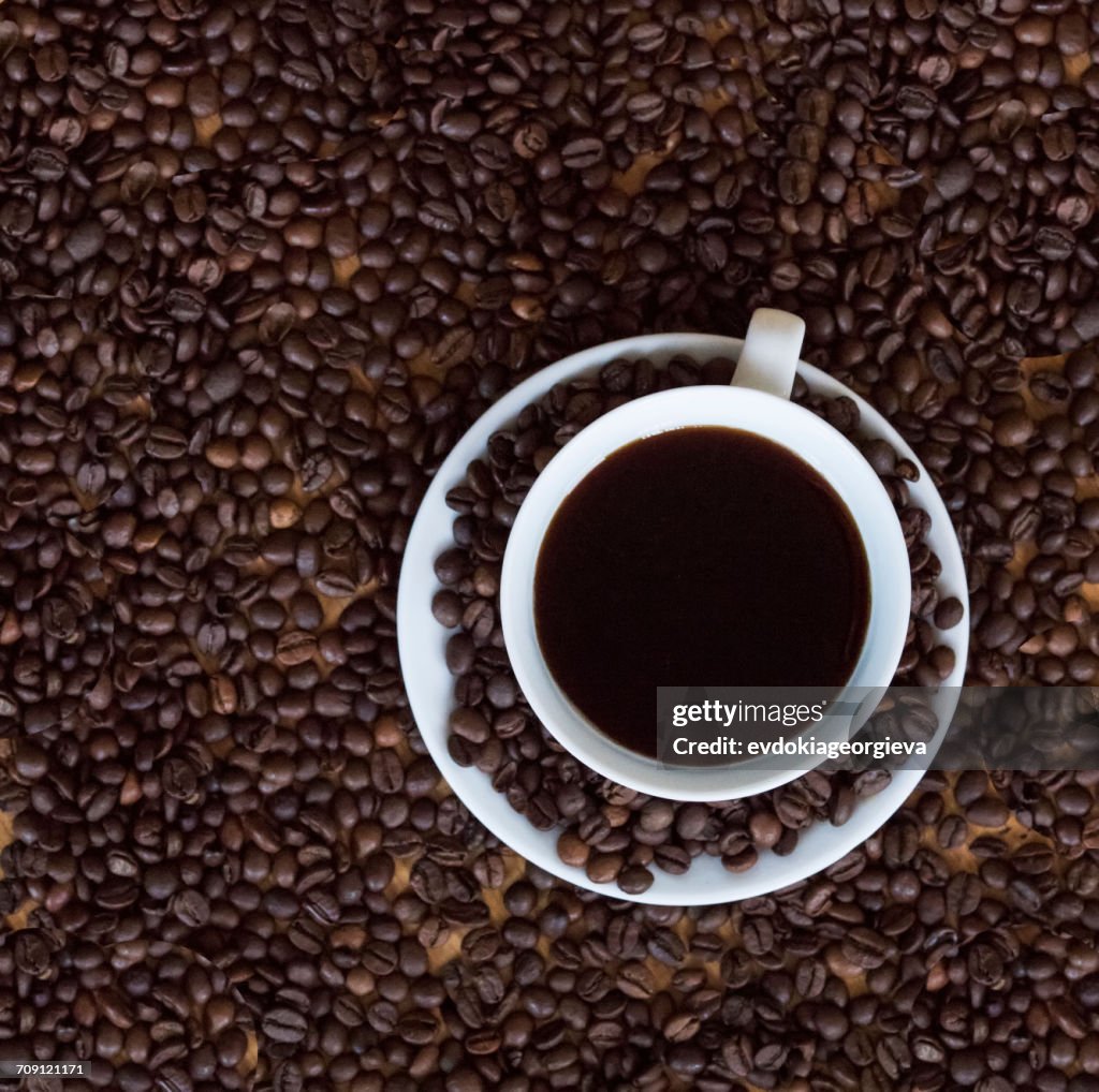 Coffee cup with roasted coffee beans