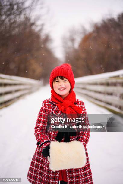 girl standing on bridge in snow with a fake fur muff - pelzmuffs stock-fotos und bilder