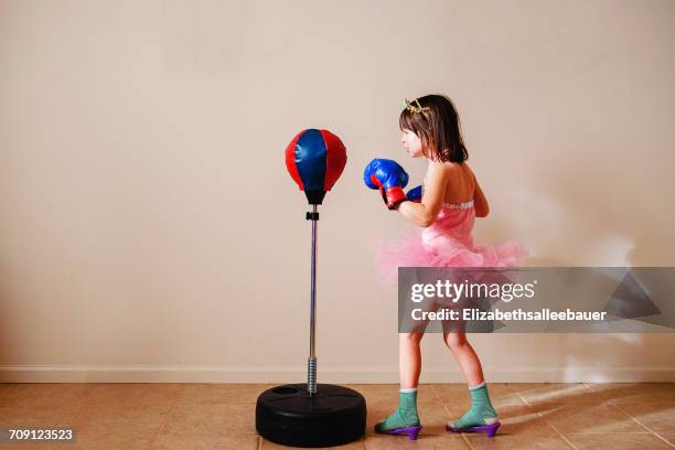 girl in pink tutu and high heel shoes learning to box - kid boxing stock pictures, royalty-free photos & images