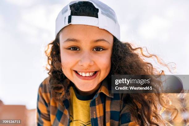 portrait of happy girl wearing baseball cap - girl baseball cap stock pictures, royalty-free photos & images