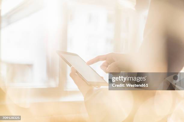 hand of businessman touching display of tablet - brightly lit office stock pictures, royalty-free photos & images